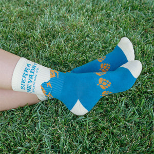 Thumbnail of A person wears the Sierra Nevada Blue Mountain Socks outside in a grassy field