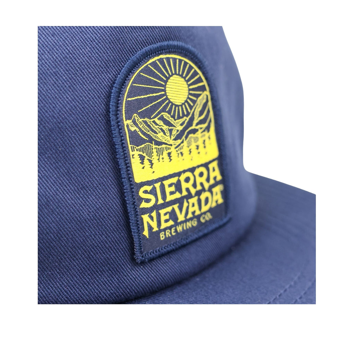 Blue cap with a yellow Sierra Nevada Brewing Co. patch on a white background