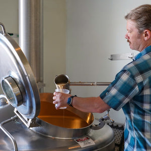 Thumbnail of A brewer tests the liquid during the brewing process for the CCBA West Coast IPA from Sierra Nevada.