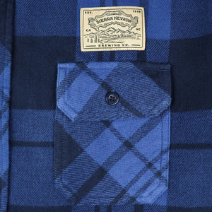Thumbnail of Blue plaid shirt with a visible brand label on a white background