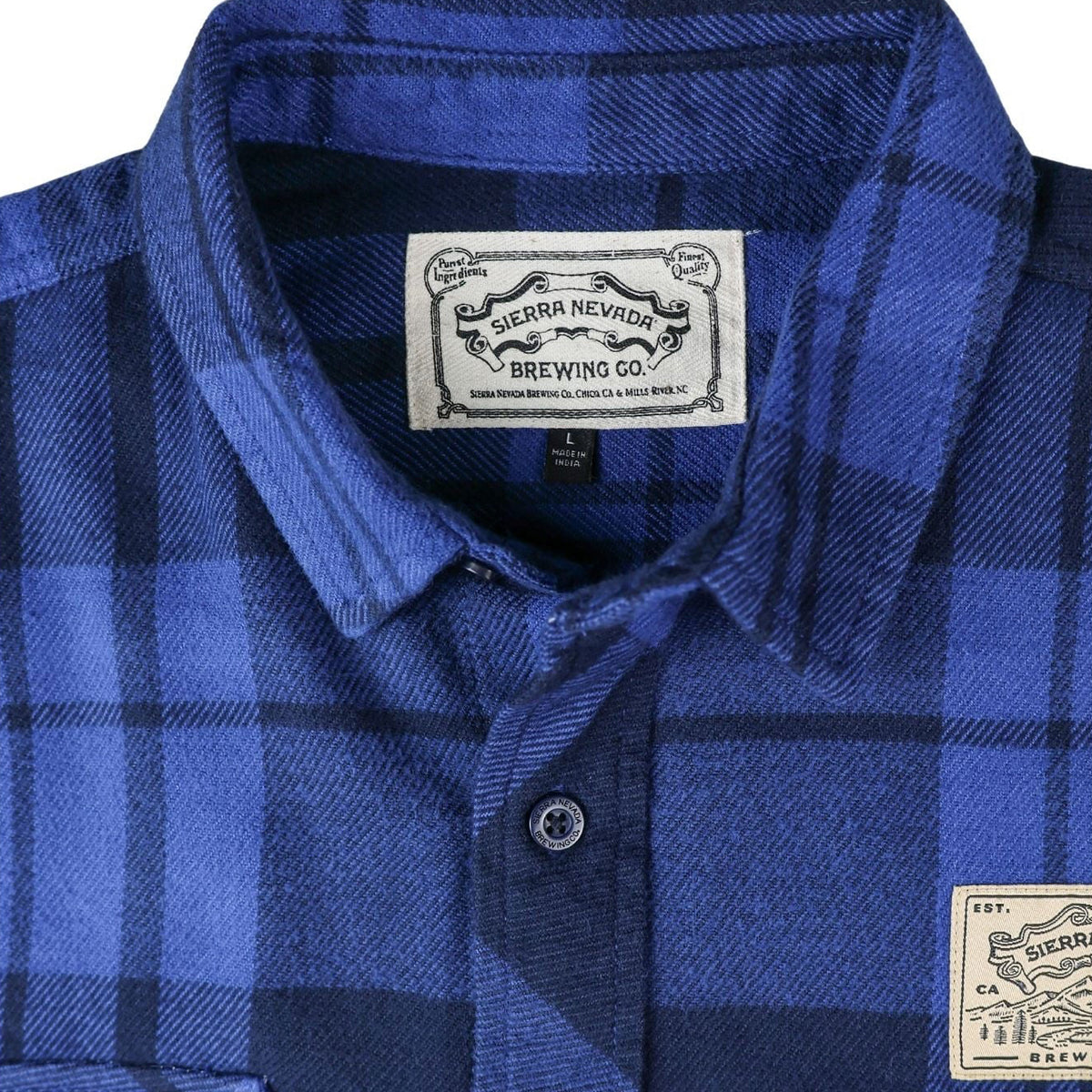 Blue plaid shirt with brand labels on a white background