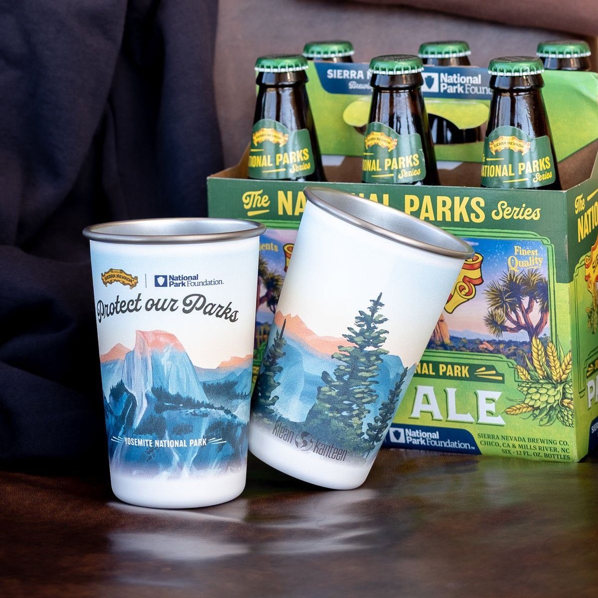 National Park Foundation products including bottles, cups, and a box on a wooden surface.