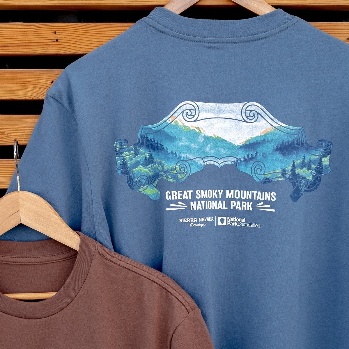Two t-shirts with Great Smoky Mountains National Park designs on a wooden background