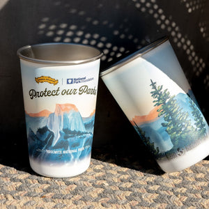 Thumbnail of Two stainless steel cups with nature-themed designs and text on a textured surface.