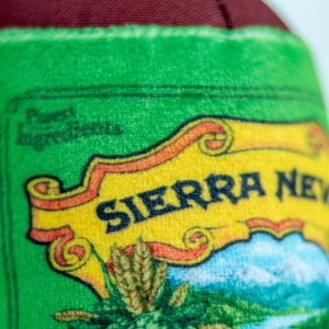 Thumbnail of Close-up of a green woven label or patch with a yellow banner reading 