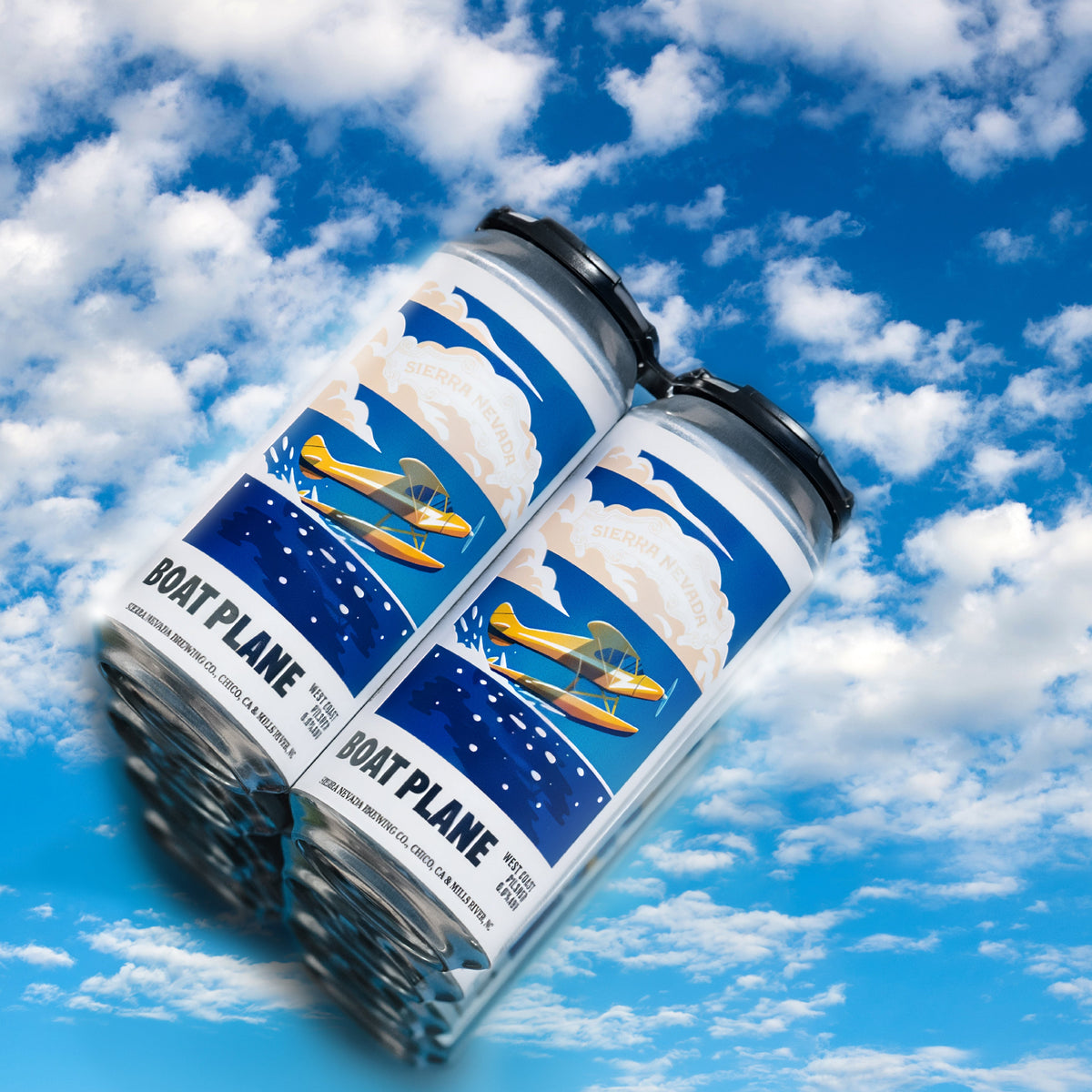 Two cans of Boat Plane against a blue sky with clouds