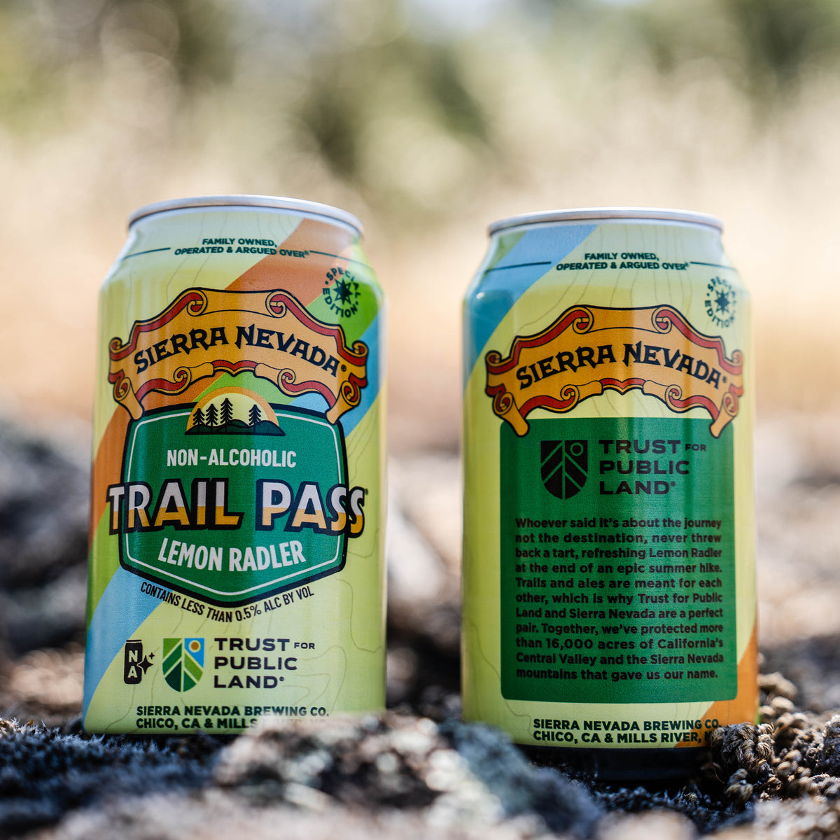 Two cans of Sierra Nevada Trail Pass Non-Alcoholic Lemon Radler on a natural background