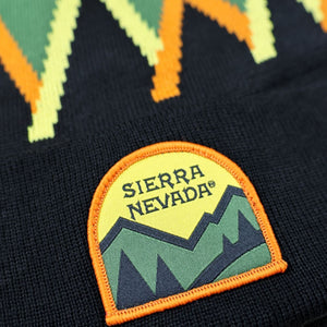 Thumbnail of Close-up of a sweater with a Sierra Nevada logo and mountain design.