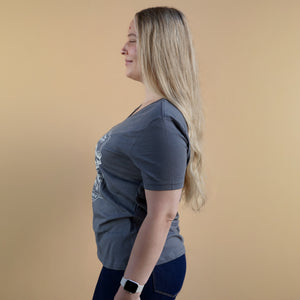 Thumbnail of Woman wearing a gray t-shirt with a pattern on a beige background
