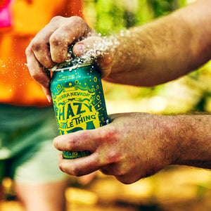Thumbnail of A man cracks open a can of Hazy Little Thing