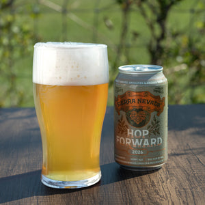 Thumbnail of Pint of beer and Sierra Nevada Hop Forward can on a wooden surface with a blurred natural background