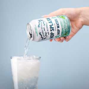 Thumbnail of Hand pouring beer from a can labeled 'Sarver's Hop Splash' into a glass against a light blue background.