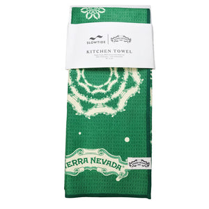 Thumbnail of Green kitchen towel with white patterns and branding on a white background