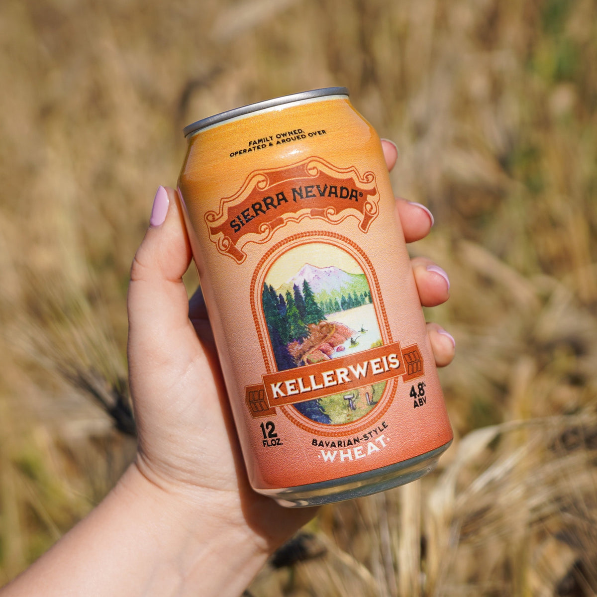 A woman holds a 12oz. can of Sierra Nevada Kellerweis.