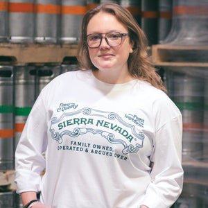Thumbnail of Person wearing a Sierra Nevada sweatshirt in front of beer barrels