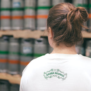Thumbnail of Person wearing a white shirt with 'Sierra Nevada' logo in a brewery setting