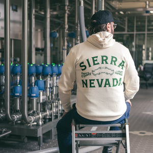 Thumbnail of Person wearing a Sierra Nevada hoodie sitting on a ladder in a brewery setting