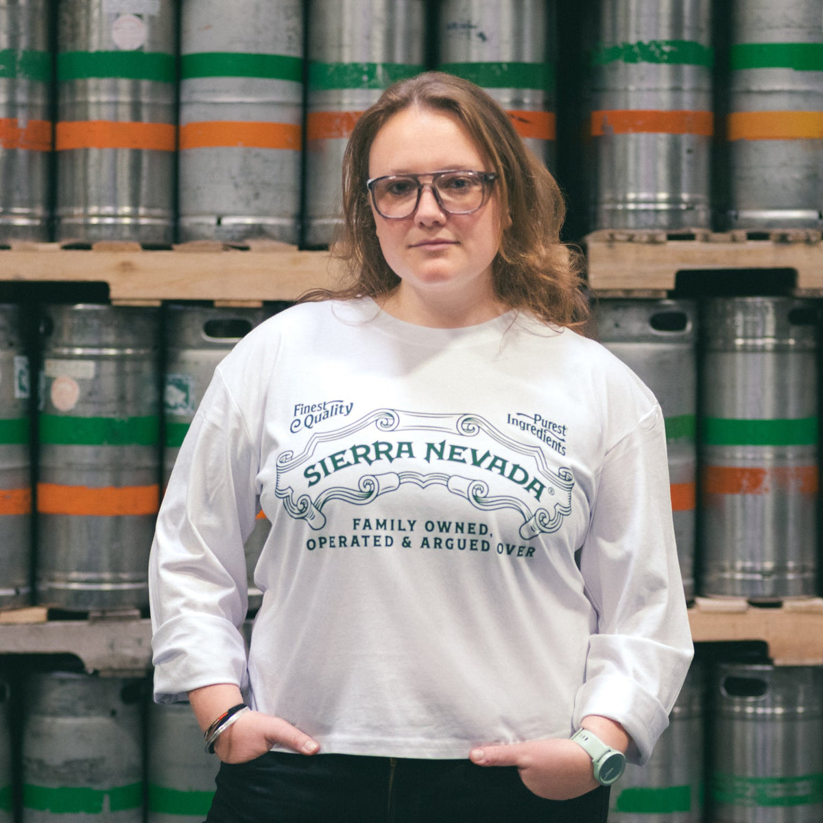 Person wearing a Sierra Nevada shirt standing in front of beer kegs