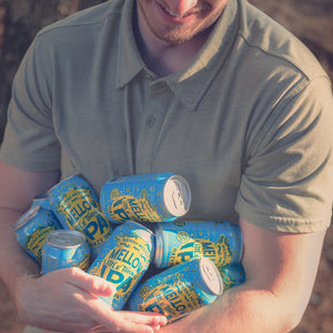 Thumbnail of A man carries an armful of Sierra Nevada Mellow Little Thing cans