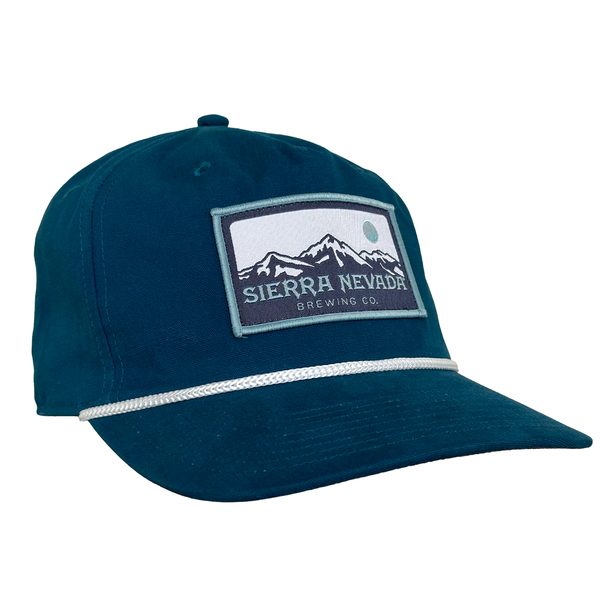 A dark teal baseball cap featuring a rectangular embroidered patch for Sierra Nevada Brewing Co. on the front, with a white stripe detail across the brim, set against a plain white background.