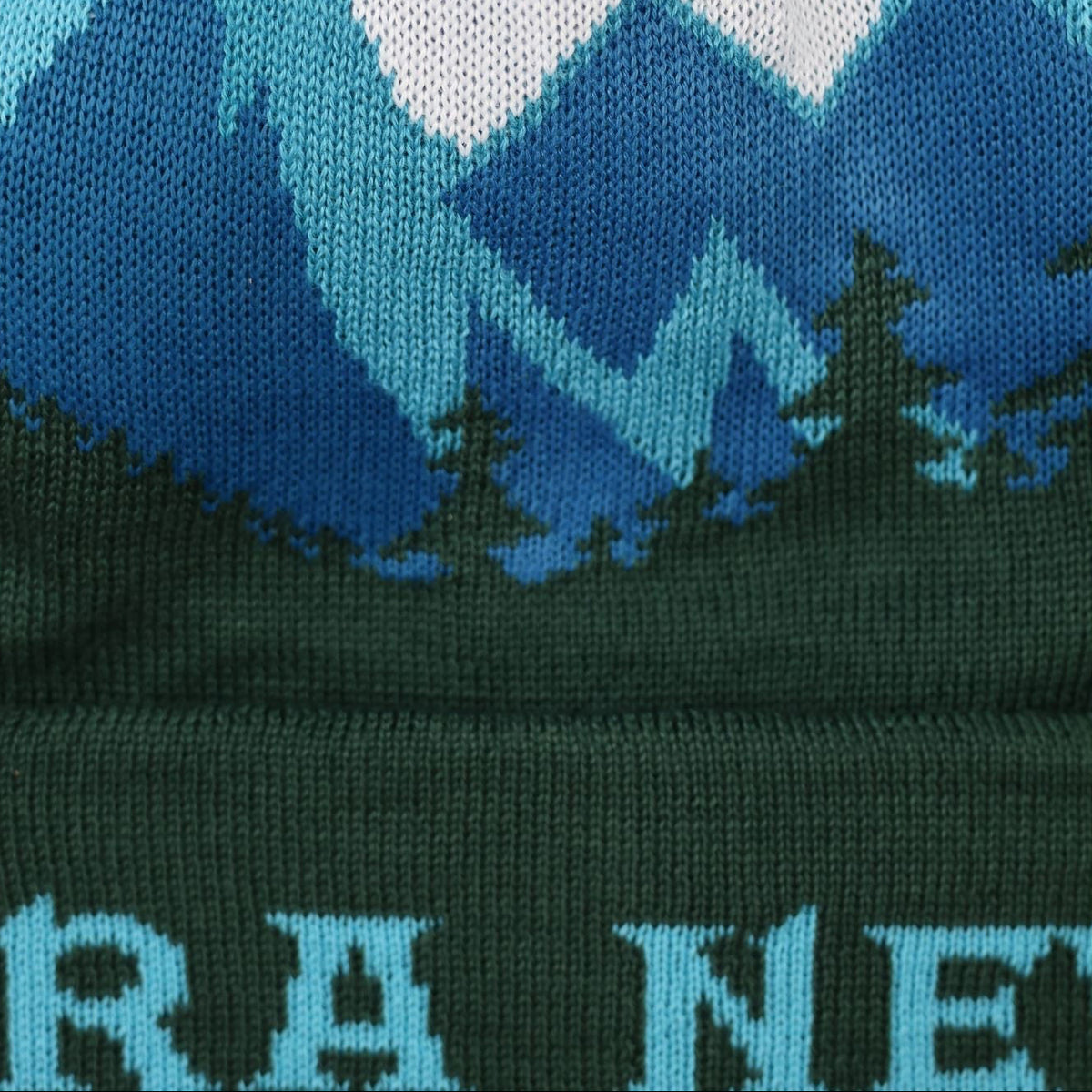 Knitted hat with mountain and forest design on a white background