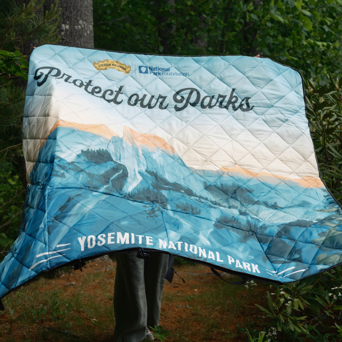 Blanket with 'Protect our Parks' and Yosemite National Park text, displayed outdoors.