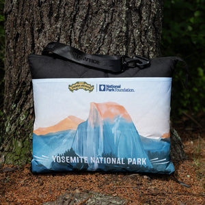 Thumbnail of Blanket with Yosemite National Park design leaning against a tree