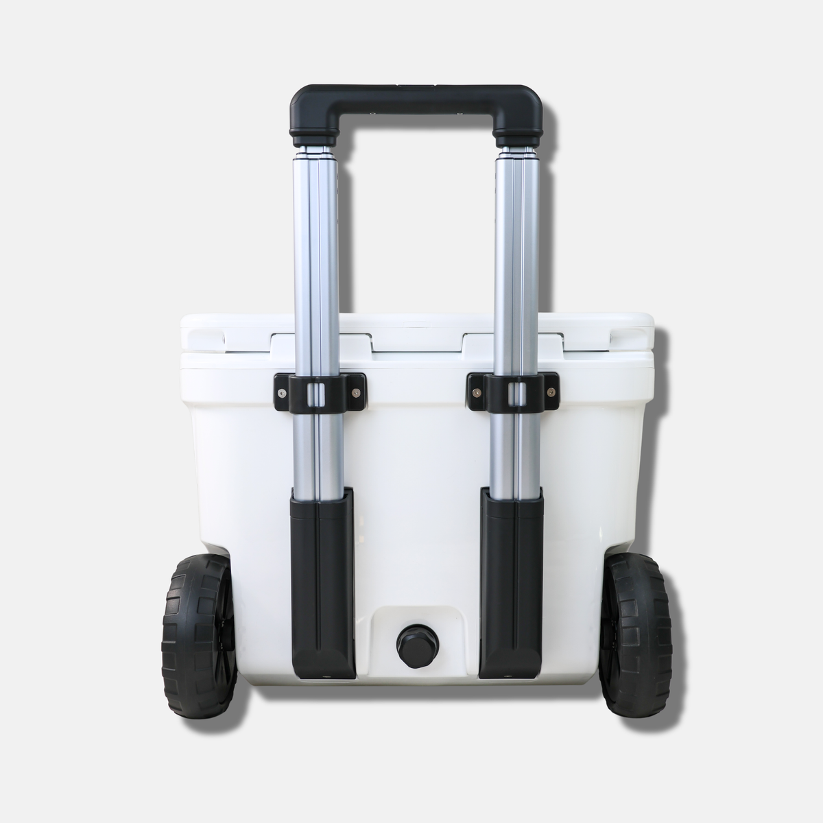 White cooler with black wheels and handle on a light gray background