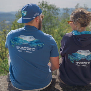 Thumbnail of Two people wearing Great Smoky Mountains National Park shirts and hoodies, sitting outdoors.