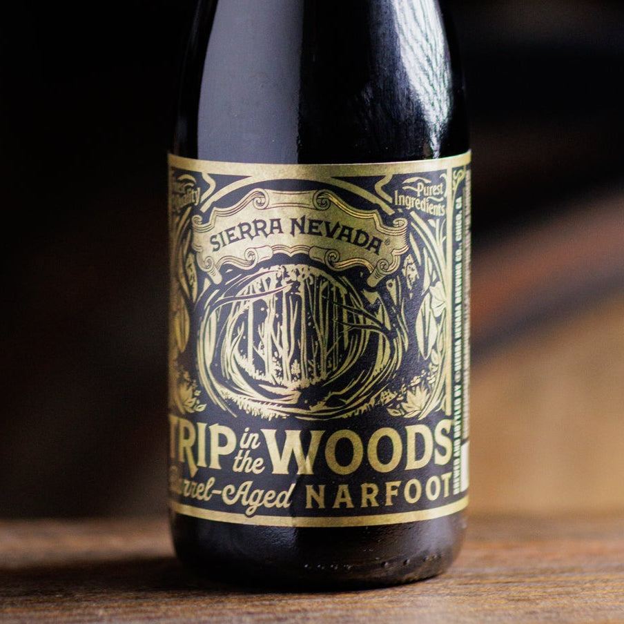 Bottle of Sierra Nevada 'Narfoot' aged in oak barrels on a wooden surface.