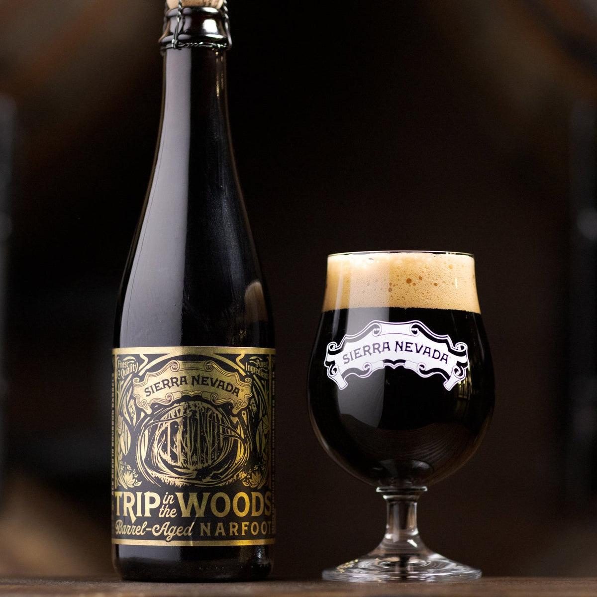 Bottle and glass of Sierra Nevada Trip in the Woods beer on a wooden surface with blurred background