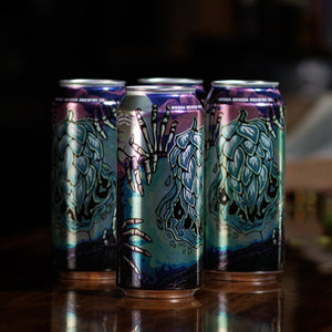 Thumbnail of Three colorful beer cans on a dark surface with a blurred background