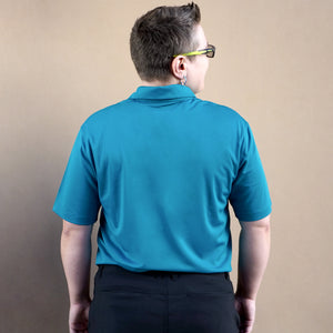 Thumbnail of Person wearing a blue polo shirt against a beige background
