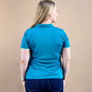Thumbnail of Person wearing a blue polo shirt against a beige background