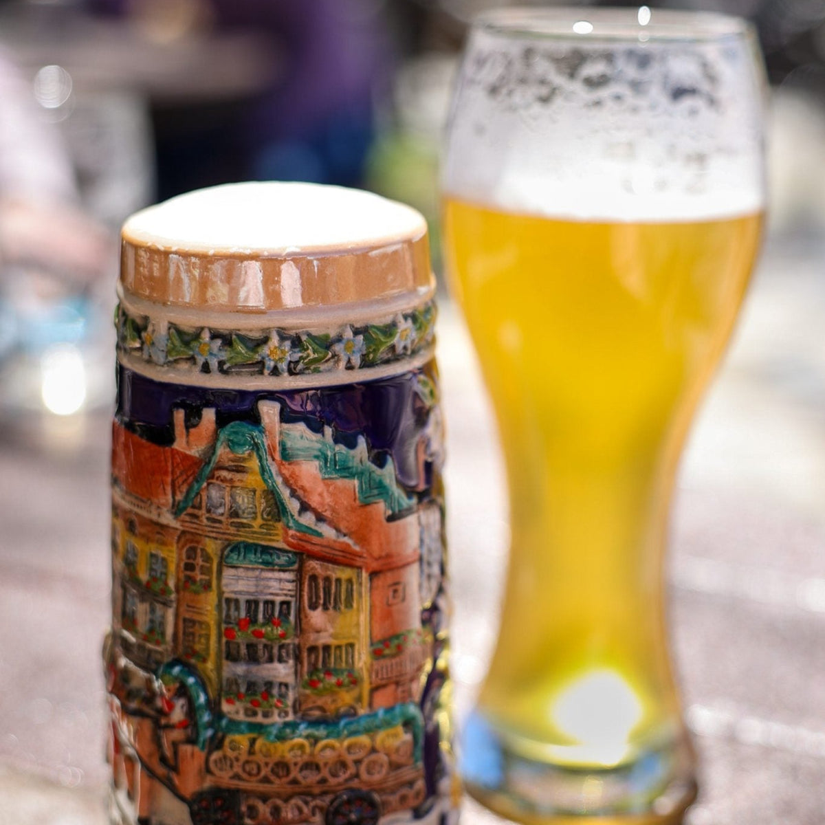 Oktoberfest beer in pint glass and stein on table outside