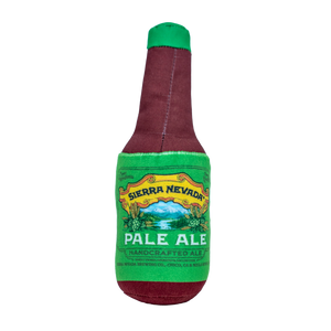 Thumbnail of A novelty plush dog toy shaped like a Sierra Nevada Pale Ale beer bottle, featuring a burgundy body with a green neck and a green label with a yellow border.