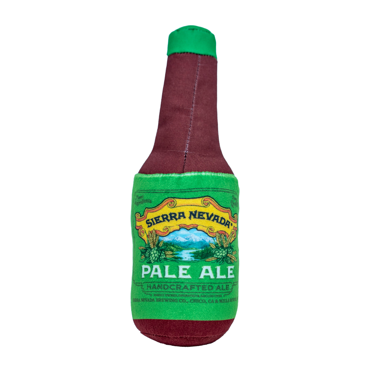 A novelty plush dog toy shaped like a Sierra Nevada Pale Ale beer bottle, featuring a burgundy body with a green neck and a green label with a yellow border.