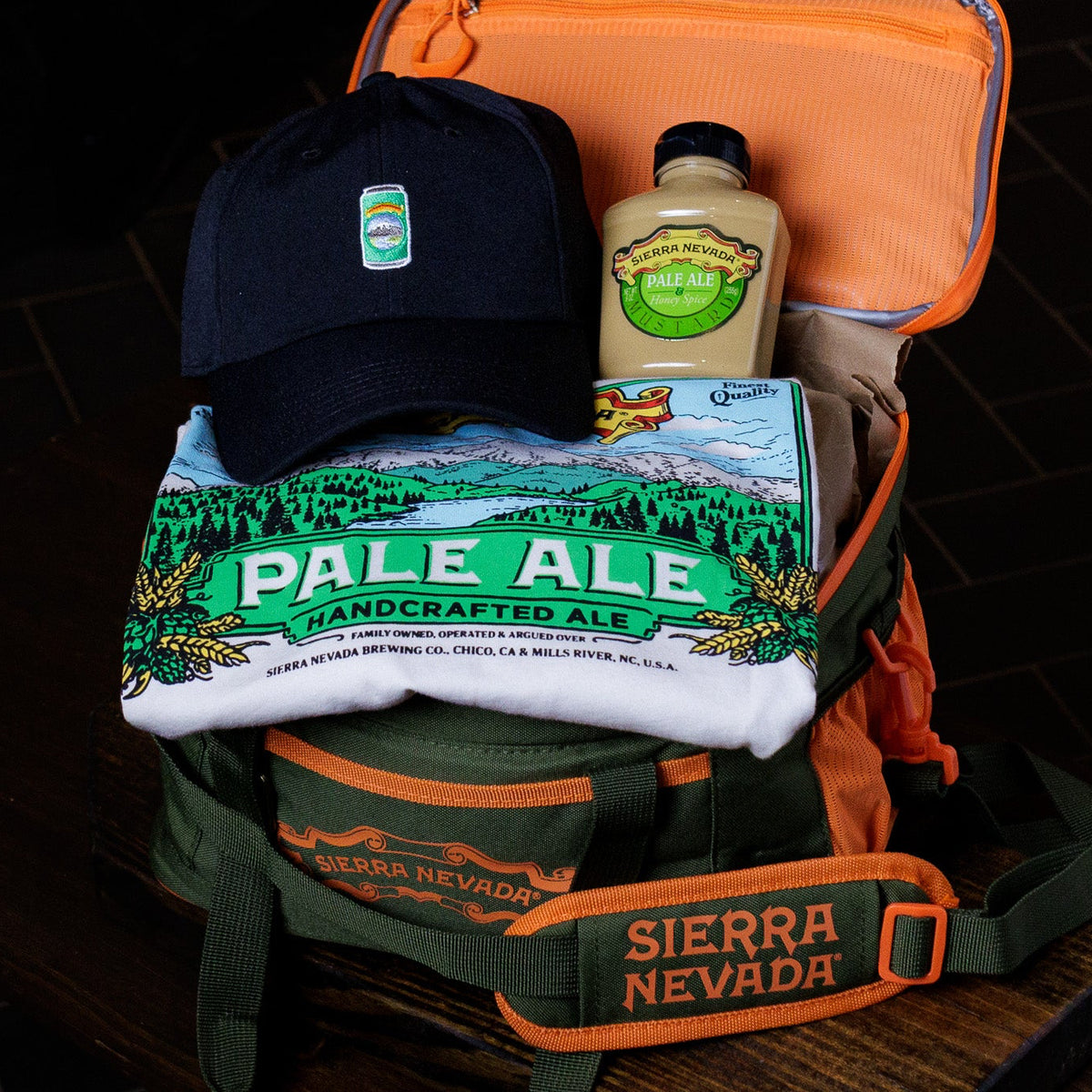 Cooler with Sierra Nevada Pale Ale branding, a bottle, and a cap on a dark tiled background