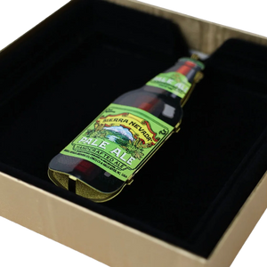 Thumbnail of A miniature bottle of Sierra Nevada Pale Ale handcrafted beer, displayed inside a black velvet-lined gift box.