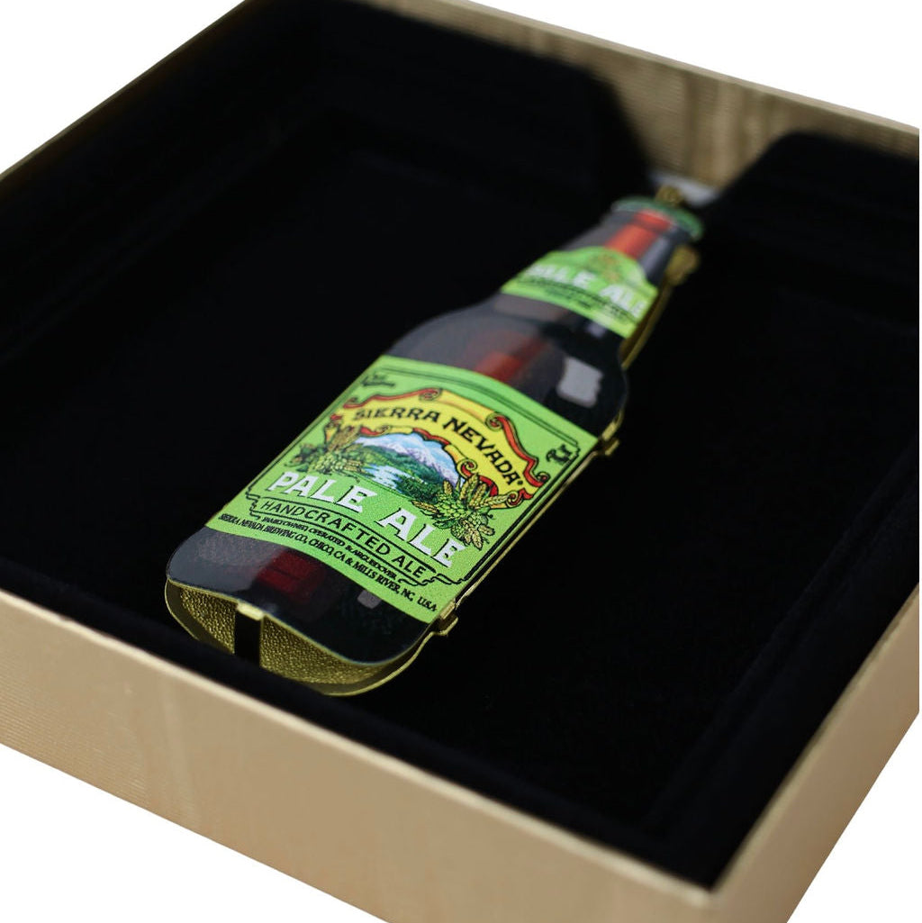 Bottle-shaped ornament with a green label on a black background