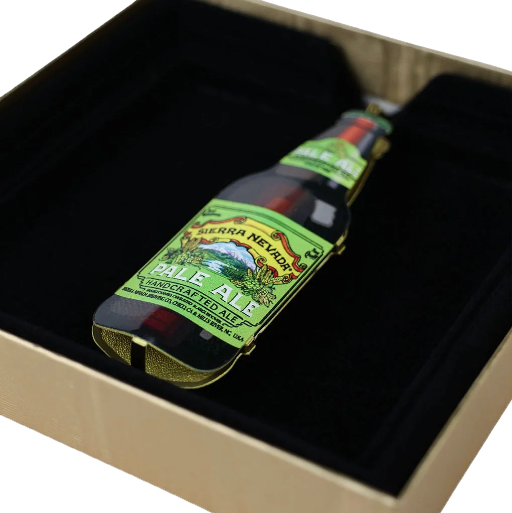 A miniature bottle of Sierra Nevada Pale Ale handcrafted beer, displayed inside a black velvet-lined gift box.