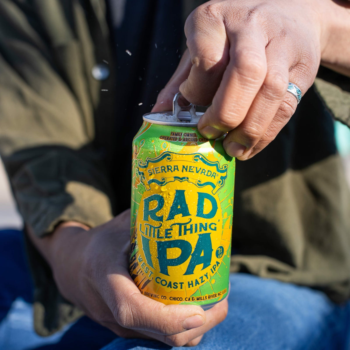 Person holding a can of 'Rad Little Thing IPA' by Sierra Nevada Brewing Company.