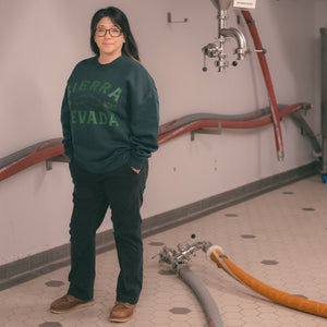 Thumbnail of Person wearing a green sweatshirt with 'Sierra Nevada' text in an industrial setting.