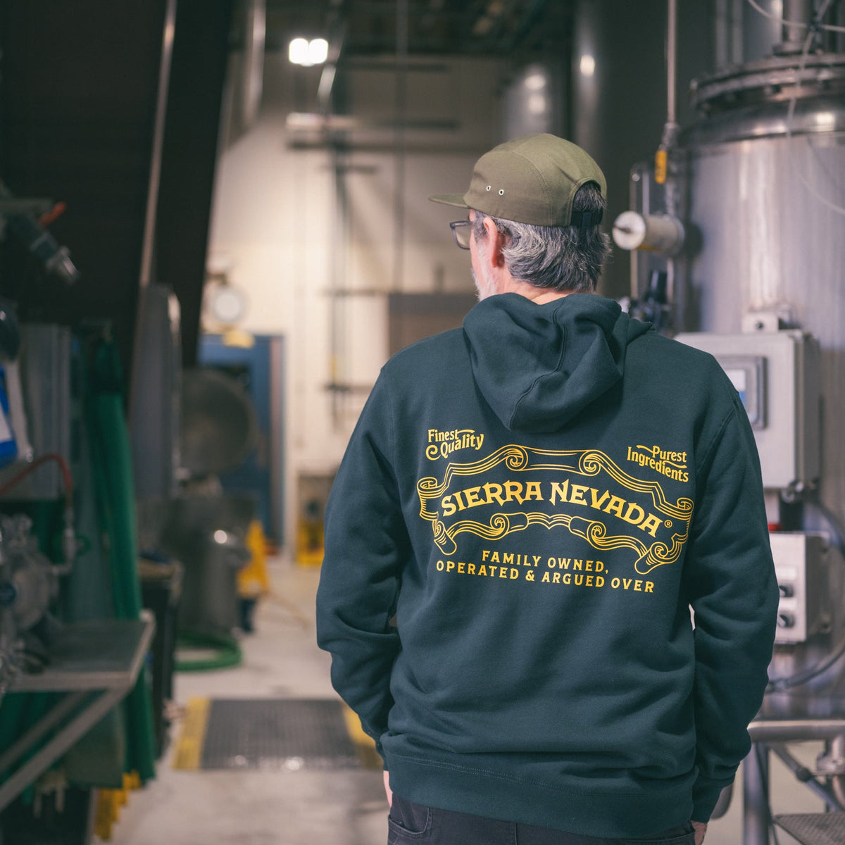 Person wearing a Sierra Nevada hoodie in an industrial setting