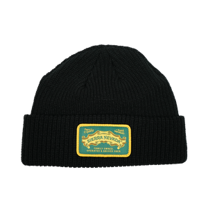 Thumbnail of Black knit beanie with a yellow and green label on a white background