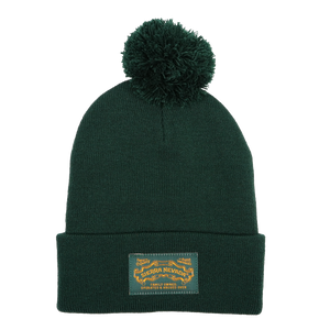 Thumbnail of Green beanie with pom-pom and label on a white background