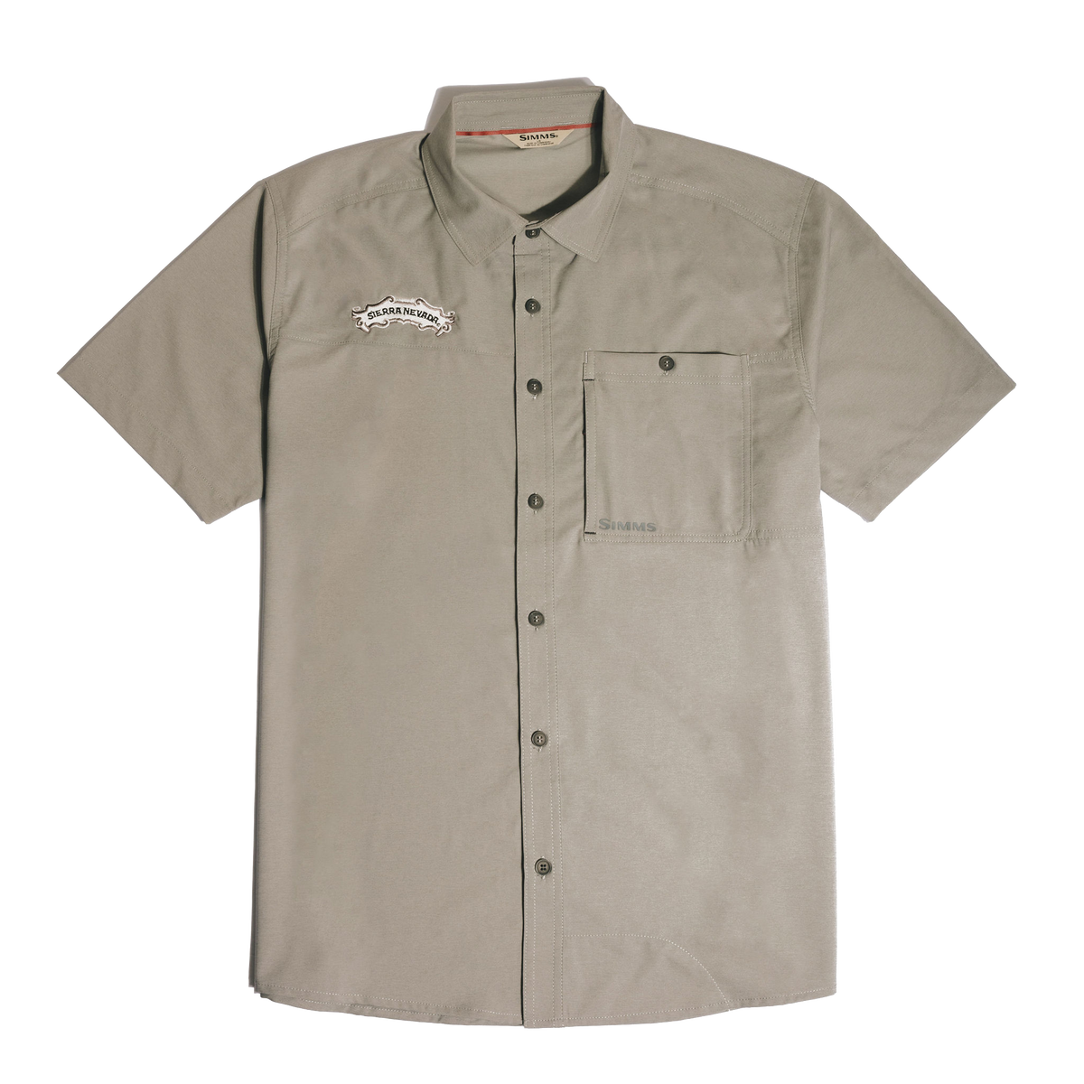 A short-sleeve button-up shirt in a light taupe-beige color, featuring a chest pocket and a small embroidered logo on the left chest, displayed against a solid white background.