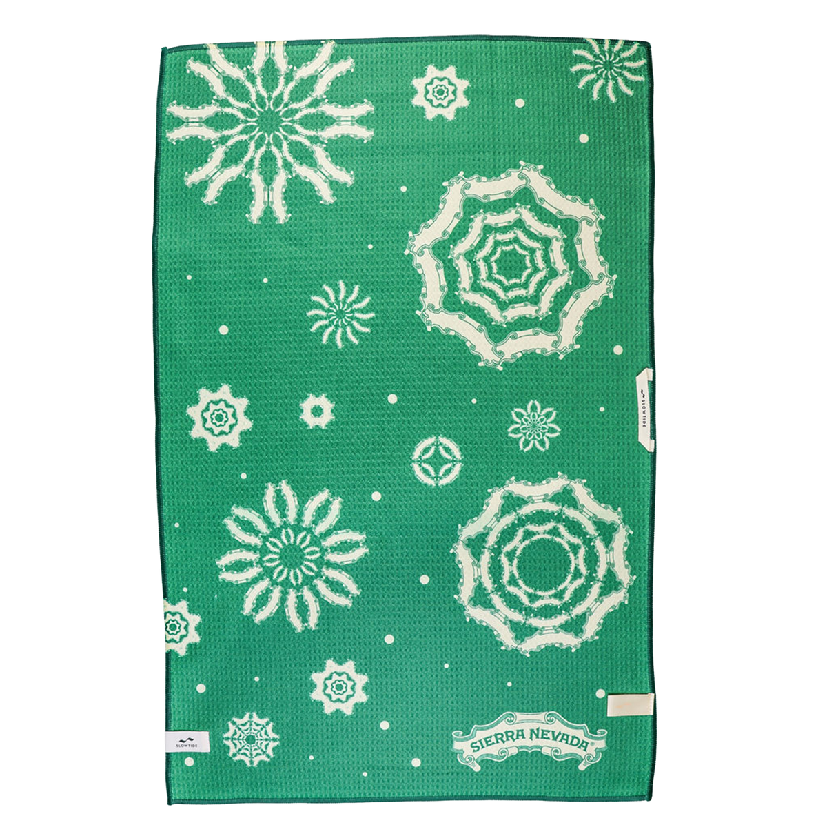 Green towel with white snowflake patterns and Sierra Nevada logo on a white background