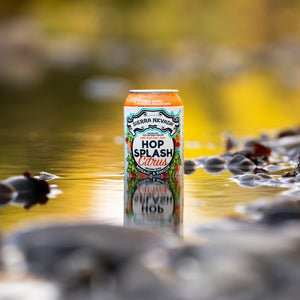 Thumbnail of Sierra Nevada Brewing Co. Hop Splash Citrus Non-Alcoholic Sparkling Hop Water - A cold can of Hop Splash Citrus sitting in a shallow pool of water surrounded by river rocks