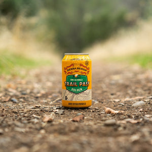 Thumbnail of Sierra Nevada Brewing Co. Trail Pass Golden Non-Alcoholic Brew - A chilled can of Trail Pass Golden sits in the middle of a hiking trail